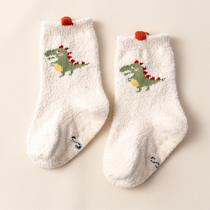 Calcetines de dinosaurio sobre fondo hueso